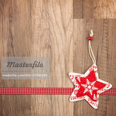 Christmas decoration with wood background, Christmas star red with ribbon