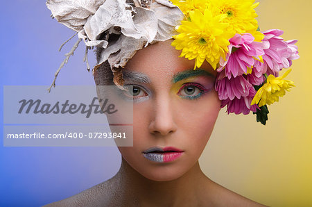 Beautiful woman in wreath of flowers of different