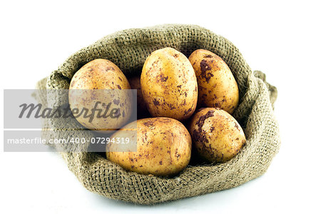 potatoes in burlap sack isolated on white background