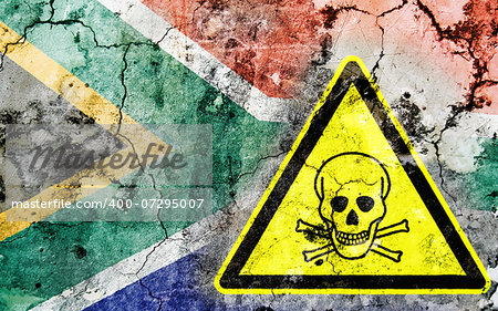 Old cracked wall with poison warning sign and painted flag, flag of South Africa