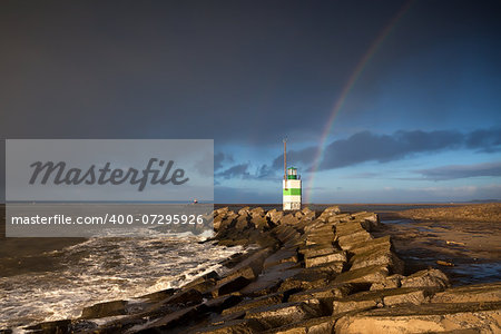 rainbow over lighthouse and North sea, Ijmuiden, Netherlands