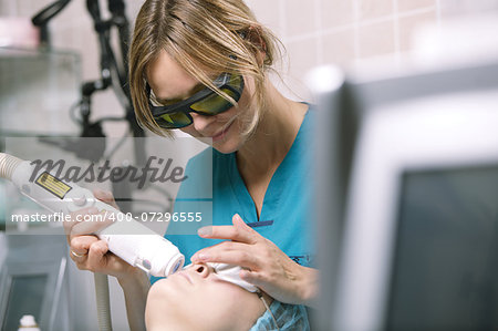 Woman having a laser skin treatment in a skincare clinic, a resurfacing technique for wrinkles, scars and solar damage to the skin of her face
