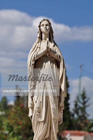Virgin Mary hands joined in prayer marble funerary statue.