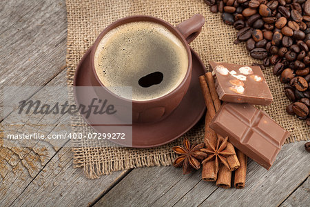 Coffee cup and spices on wooden table texture