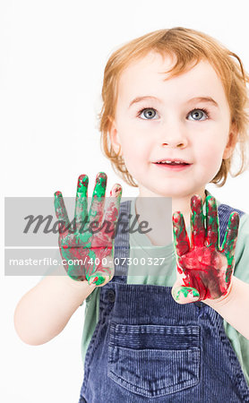 cute little girl with finger paint. vertical image in light grey background