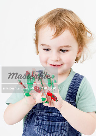 cute little girl with finger paint. vertical image in light grey background