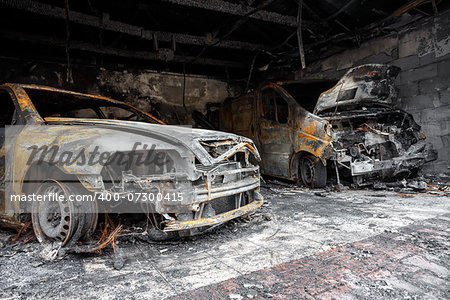 Close up photo of a burned out cars in garage after fire for grunge use