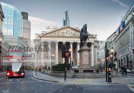 Red Bus in motion in City of London on contemporary buildingd