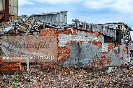 Destroyed industrial building constructed of red bricks on crisis time