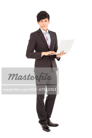 young businessman standing with laptop