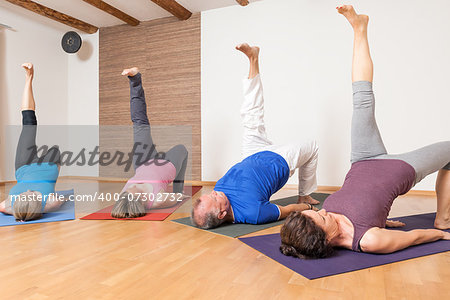 An image of some people doing yoga exercises - Eka Pada Setu Bandha Sarvangasana
