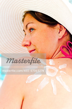 girl in hat on the beach protects the skin from the sun