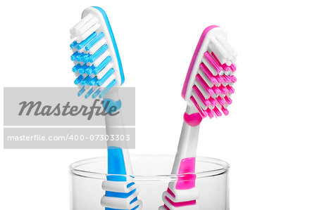 Head Toothbrush standing in a glass on a white background