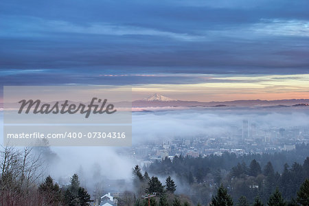 Portland Oregon Downtown Cityscape Covered in Fog and Low Clouds at Sunset with Mount Hood