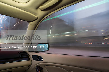 Car interior on driving. Blurred night lights