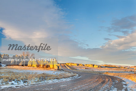 back country road over prairie in northern Colorado with Natural Fort geological landmark