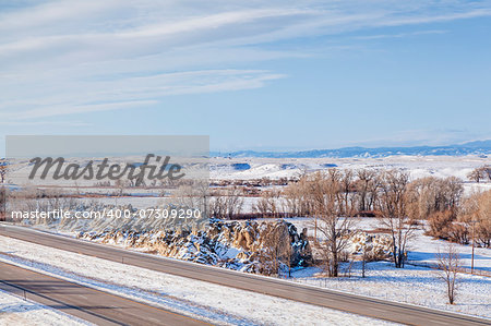 I-25 freeway in winter scenery at Natural Fort geological landmark in northern Colorado near Wyoming border
