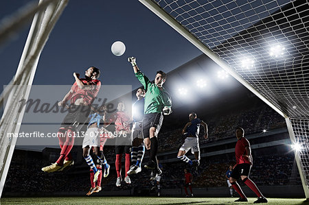 Soccer players defending goal