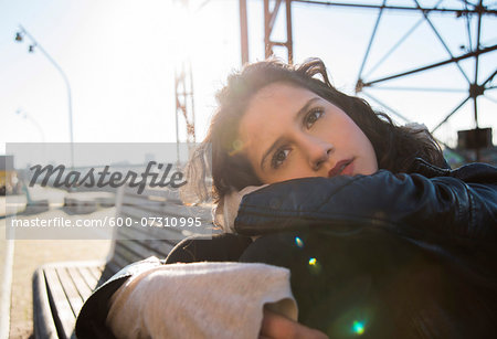 Close-up portrait of teenage girl outdoors, looking into the distance and daydreaming, Germany