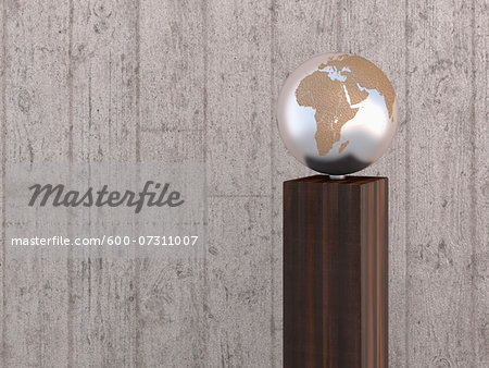 Illustration of metal globe on wooden stand, showing Africa, Europe and Asia, studio shot on grey, wooden background