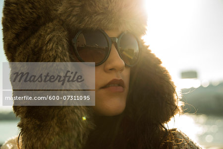 Close-up portrait of teenage girl wearing sunglasses and trapper hat, Germany