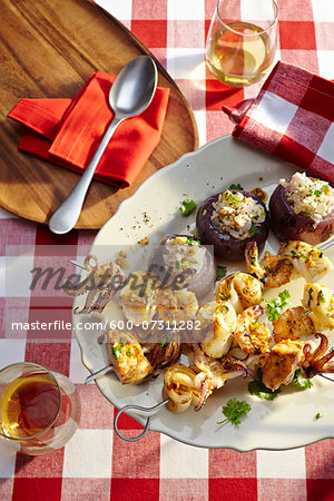 Overhead View of Seafood Kebobs and Stuffed Onions at Picnic