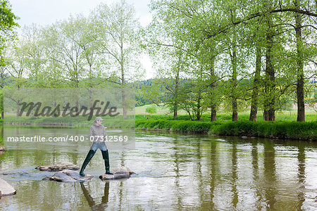 woman fishing in Sazava river, Czech Republic