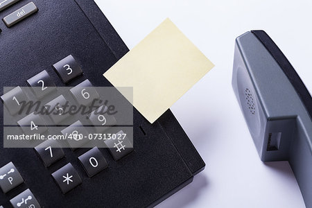 memo post it message on telefone in office reminder object business