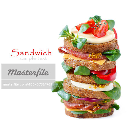 Sandwiches with sausage, cheese, vegetables and mustard on crusty fresh sliced rye bread.