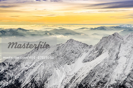 Scenic view of misty winter mountains with colorful sunset, High Tatras, Slovakia