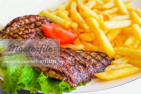 juicy steak beef meat with tomato and potatoes
