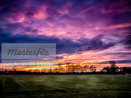 Romantic red clouds over a bavarian landscape at sunset