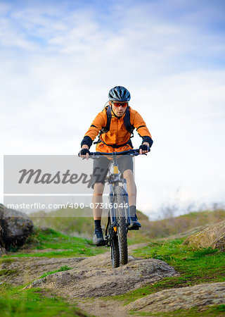 Cyclist Riding the Bike on the Beautiful Spring Mountain Trail