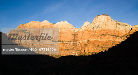 The light has not quite reached the valley int this vertical composition of early morning in the desert Southwest