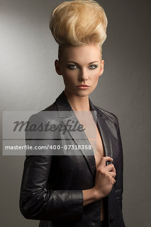 cool portrait of charming blond girl with fashion rock style, creative hairdo and leather jacket
