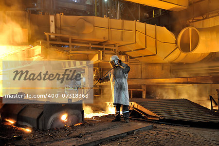 worker with hot steel in plant