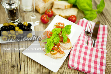 fresh tasty italian bruschetta with tomato on wooden background