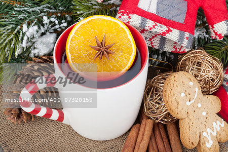 Christmas mulled wine with fir tree, gingerbread and decor on wooden table