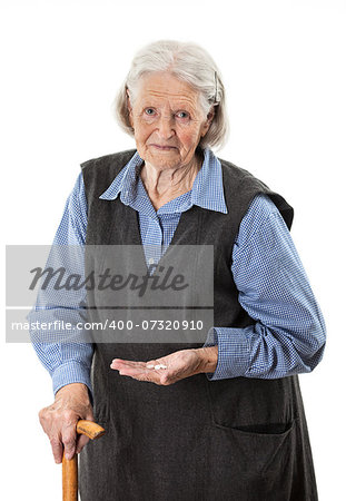 Senior woman holding medications over white