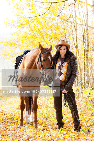 equestrian with her horse in autumnal nature