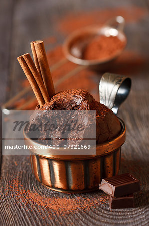 Delicious chocolate muffins with cinnamon and chocolate bar close-up.