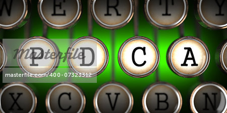 PDCA - Plan-Do-Check-Act - on Old Typewriter's Keys on Green Background.
