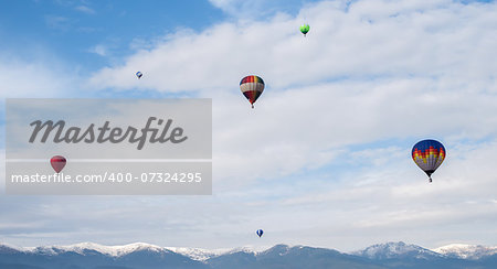 Multicolored Balloons in the blue cloudy sky