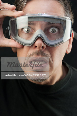 Close-up of a crazy man wearing goggles.