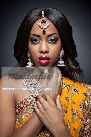 Young Indian woman dressed in traditional clothing with bridal makeup and jewelry