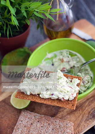 Avocado and feta cheese appetizer on a crispbread, ready to eat