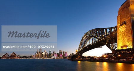 View of Sydney Harbour at dusk with the Harbour Bridge to the side