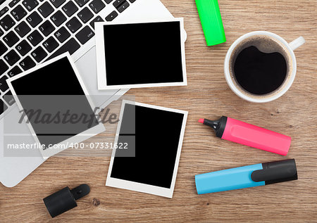 Blank instant photo frames over office table. View from above