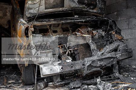 Close up photo of a burned out cars in garage after fire for grunge use