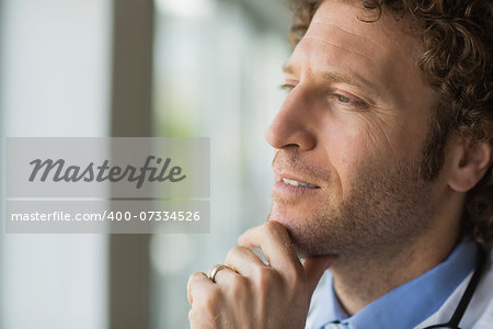 Closeup of thoughtful male doctor with hand on chin